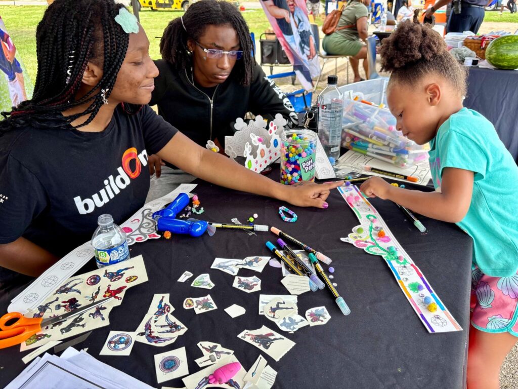 buildOn students serve at a backpack giveaway in Detroit.