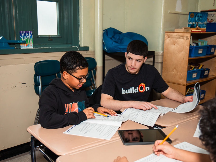 A buildOn student helps tutor a younger student at P.S. 35 in the Bronx.