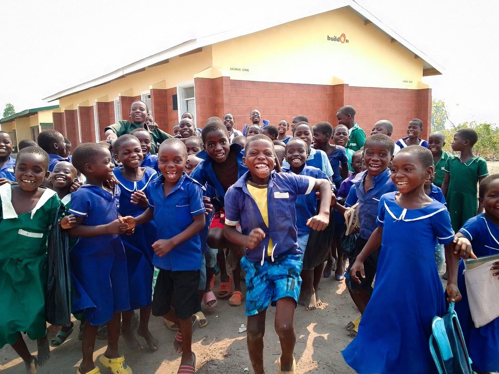 Students celebrate in front of their new buildOn school in Kachikho, Malawi.