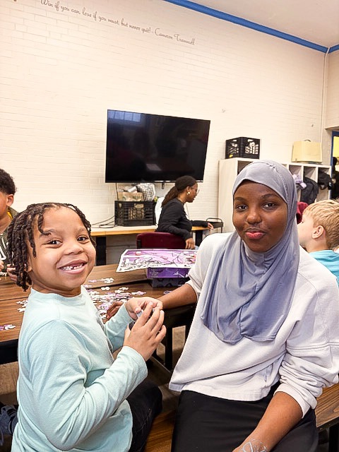 Ikran serves with local children at All Dorchester Sports and Leadership's after school program.