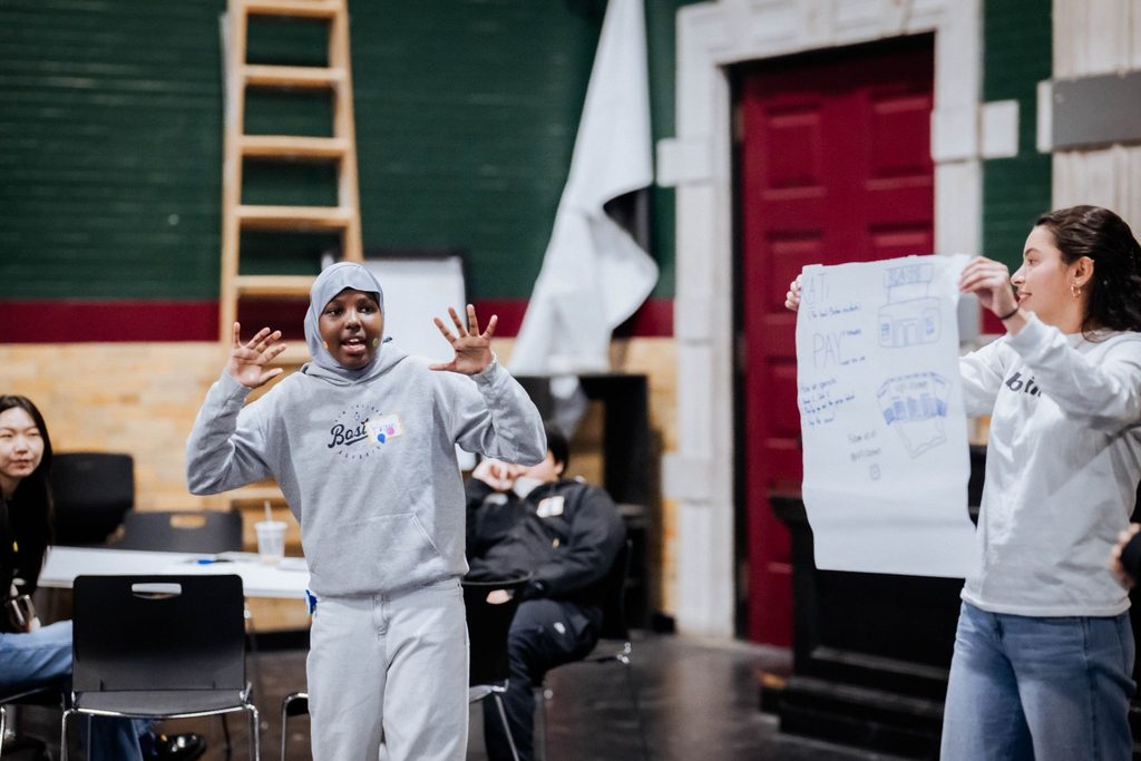 Ikran speaks at an Earth day clothing swap service immersion with EY.