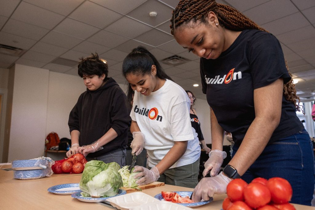 buildOn students from the Bronx and Bridgeport prepare tacos at Harrison Apartments, a supportive housing building in Bridgeport.