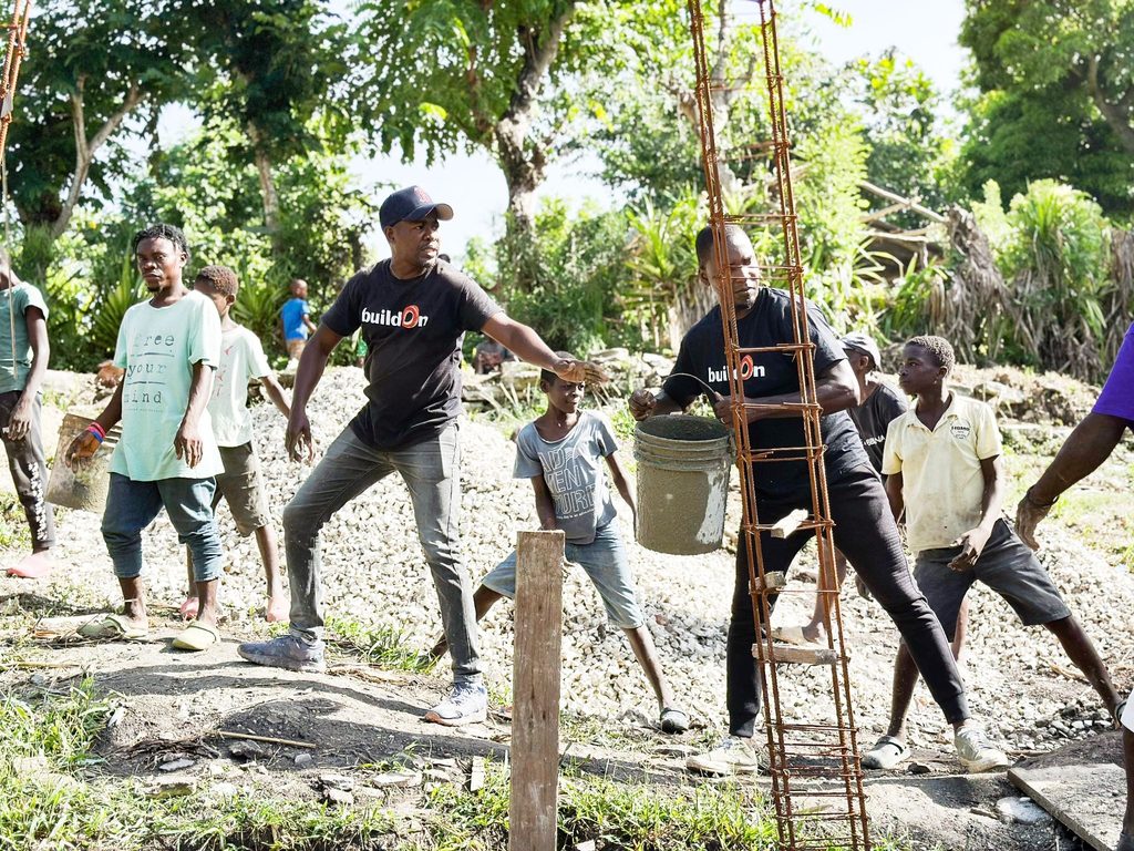 buildOn staff and community members on the worksite in Navarre, Haiti.