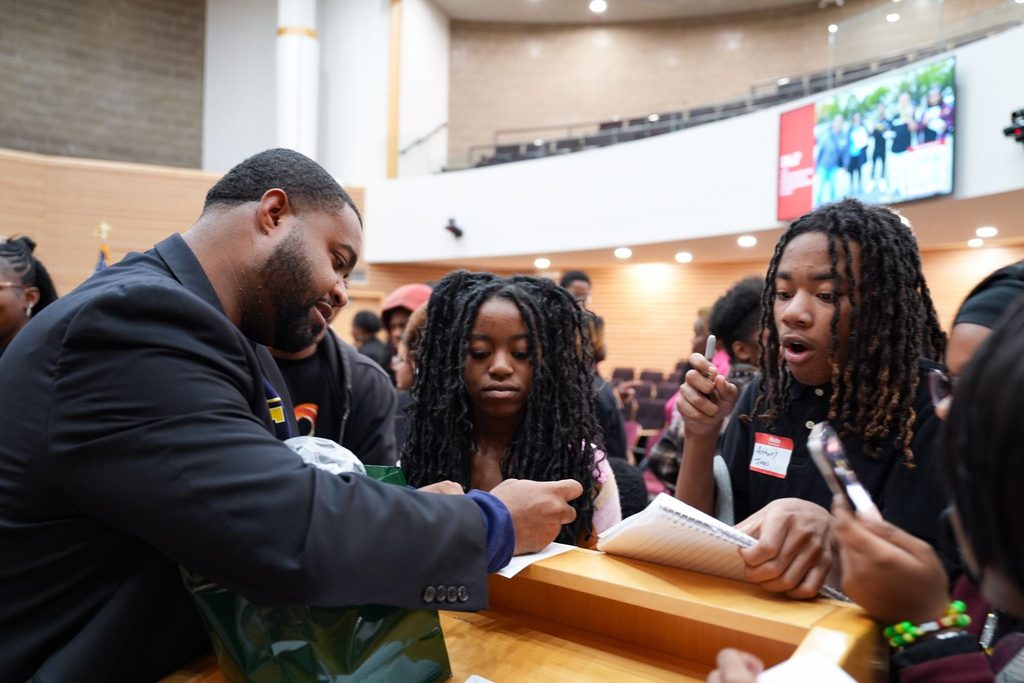 State Representative and buildOn alum Donavan McKinney meeting students and signing autographs after the event.  