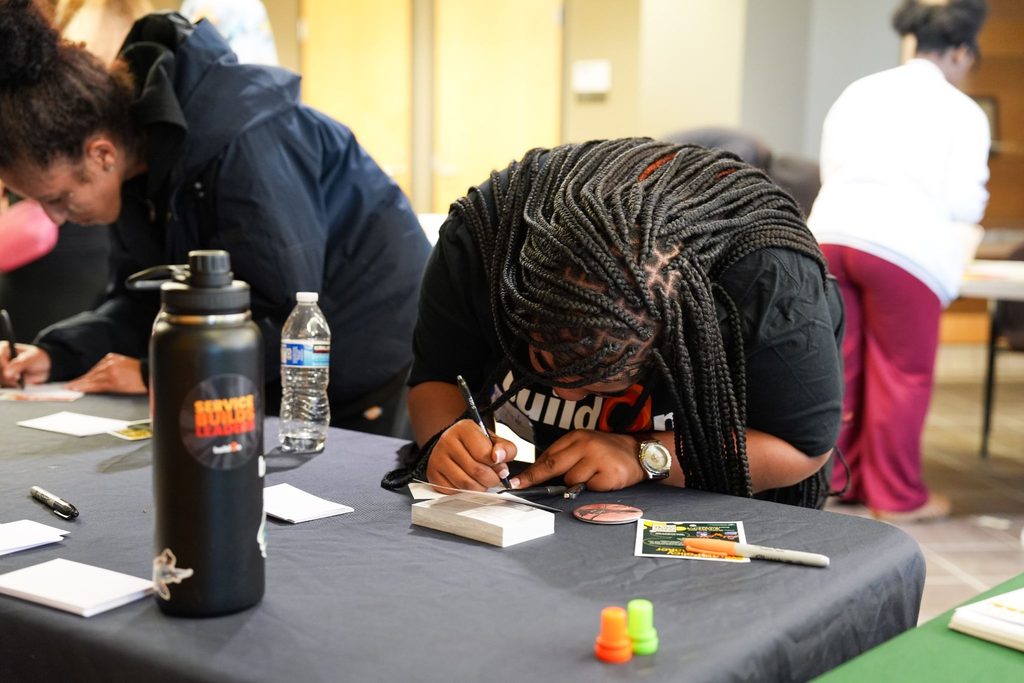 buildOn in Detroit students hard at work on voter postcards.