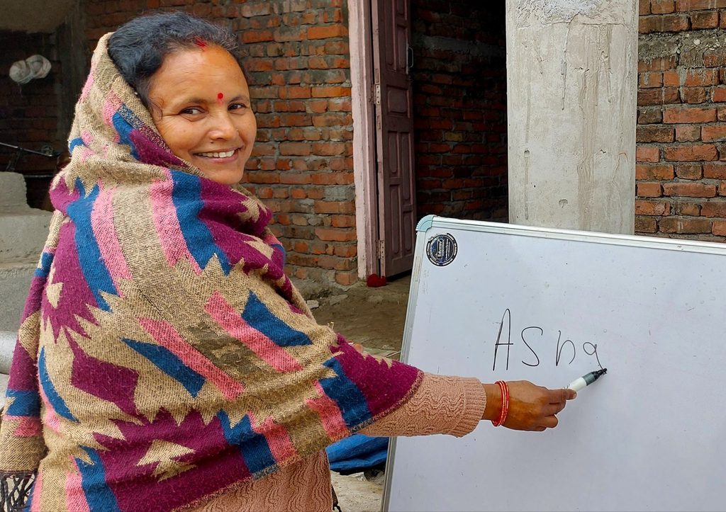 Asha can now write her name and do calculations to run her business thanks to buildOn’s Adult Literacy Program.